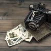 vintage camera and album with old photos on wooden table. nostalgic picture vintage camera and album with old photos on wooden table. nostalgic picture